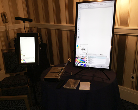 The digital caricature setup, including the tablet, printer and display screen.