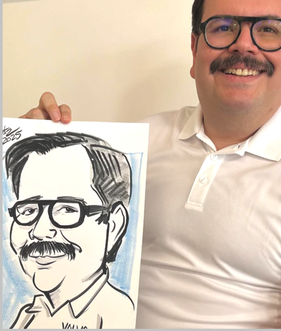 Young man holding his caricature by caricature artist "Gootz"