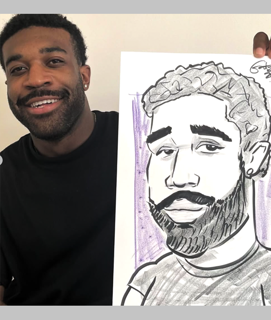 Young man holding his caricature by "Gootz"