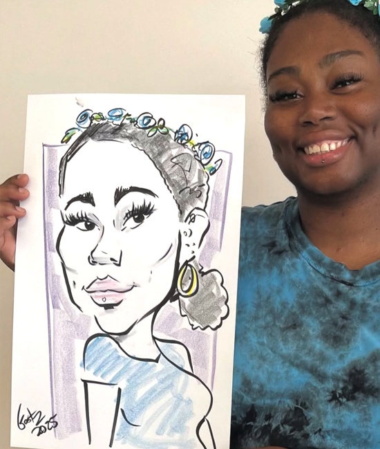 A young lady holding her caricature